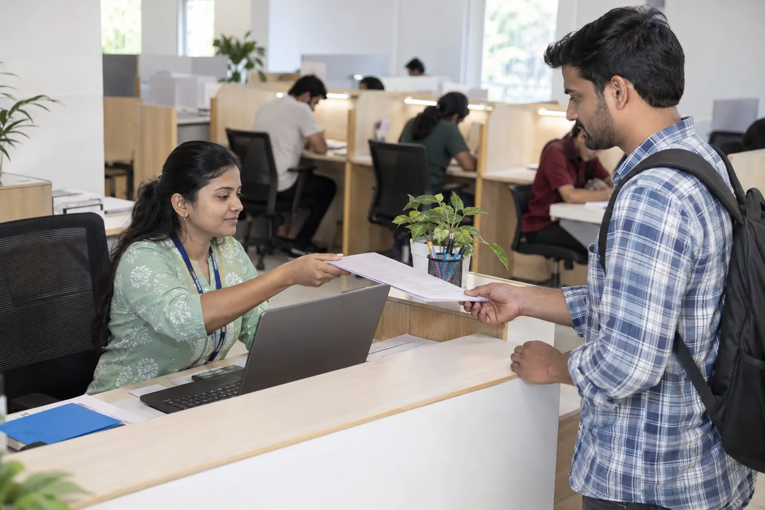 Reception staff handing a payment document to a study-library member